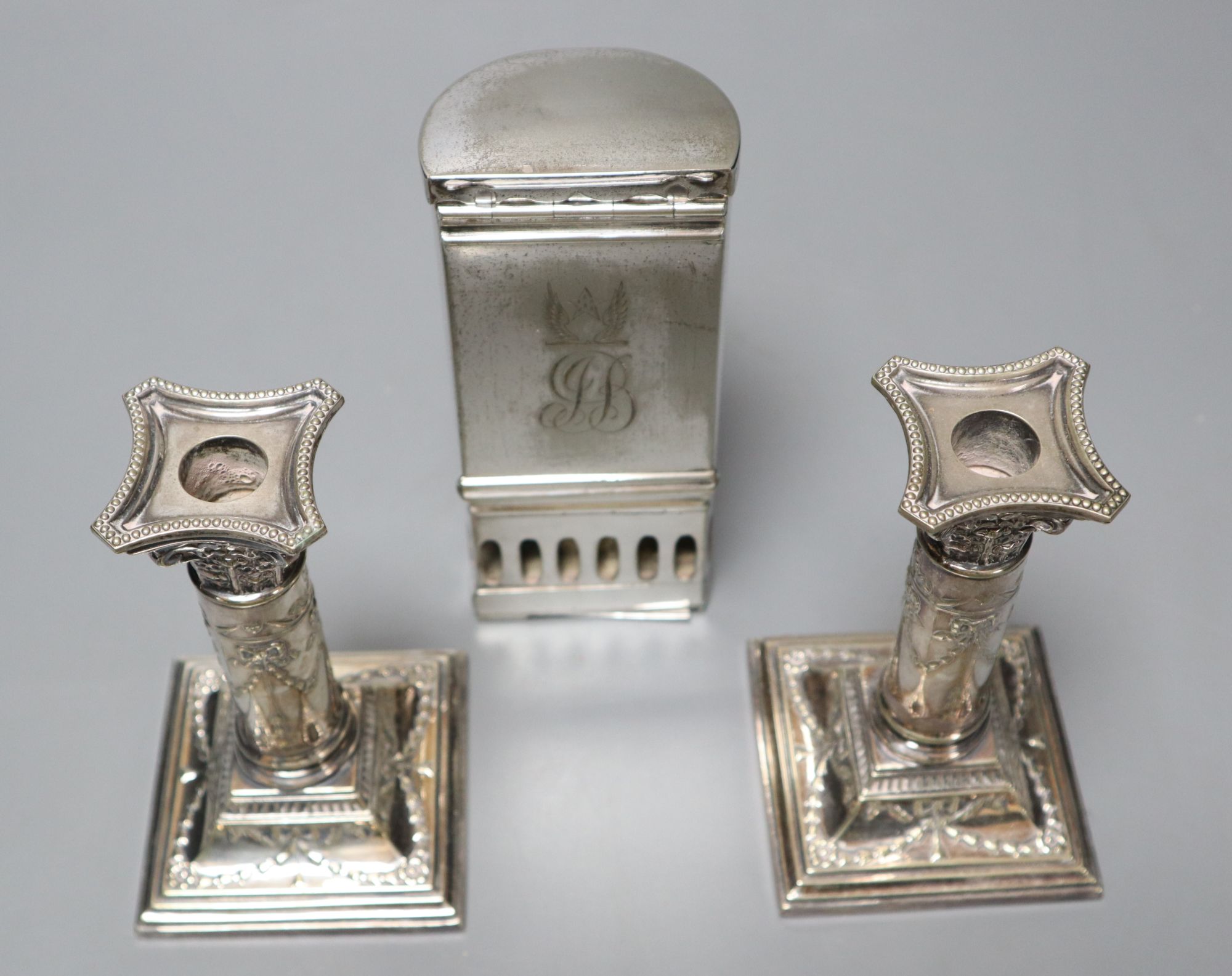 A pair of Victorian plated and embossed dwarf candlesticks and a Victorian plated pocket lamp, height 24cm (3)